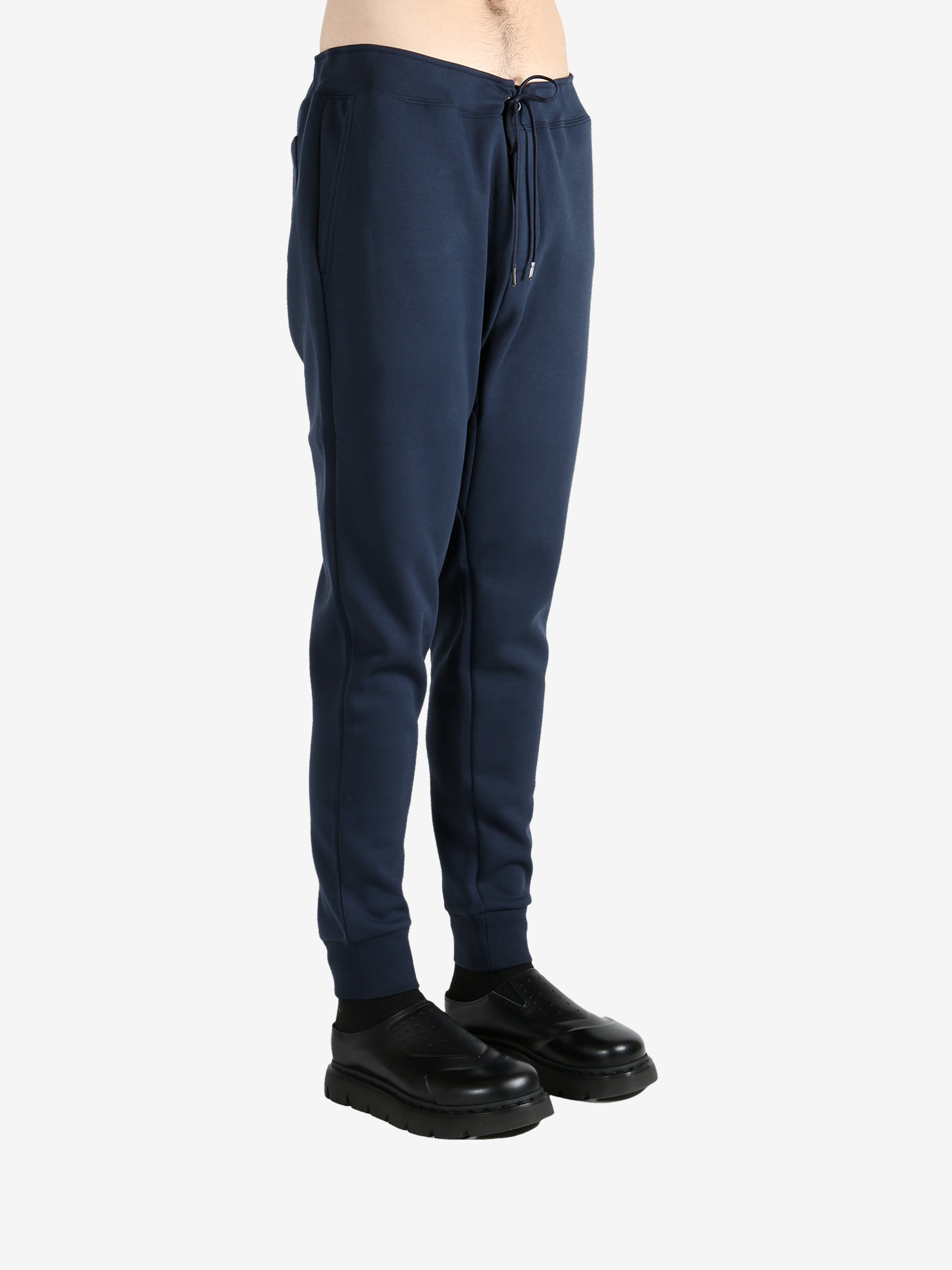 Navy pants worn by a person, showing the pants fit