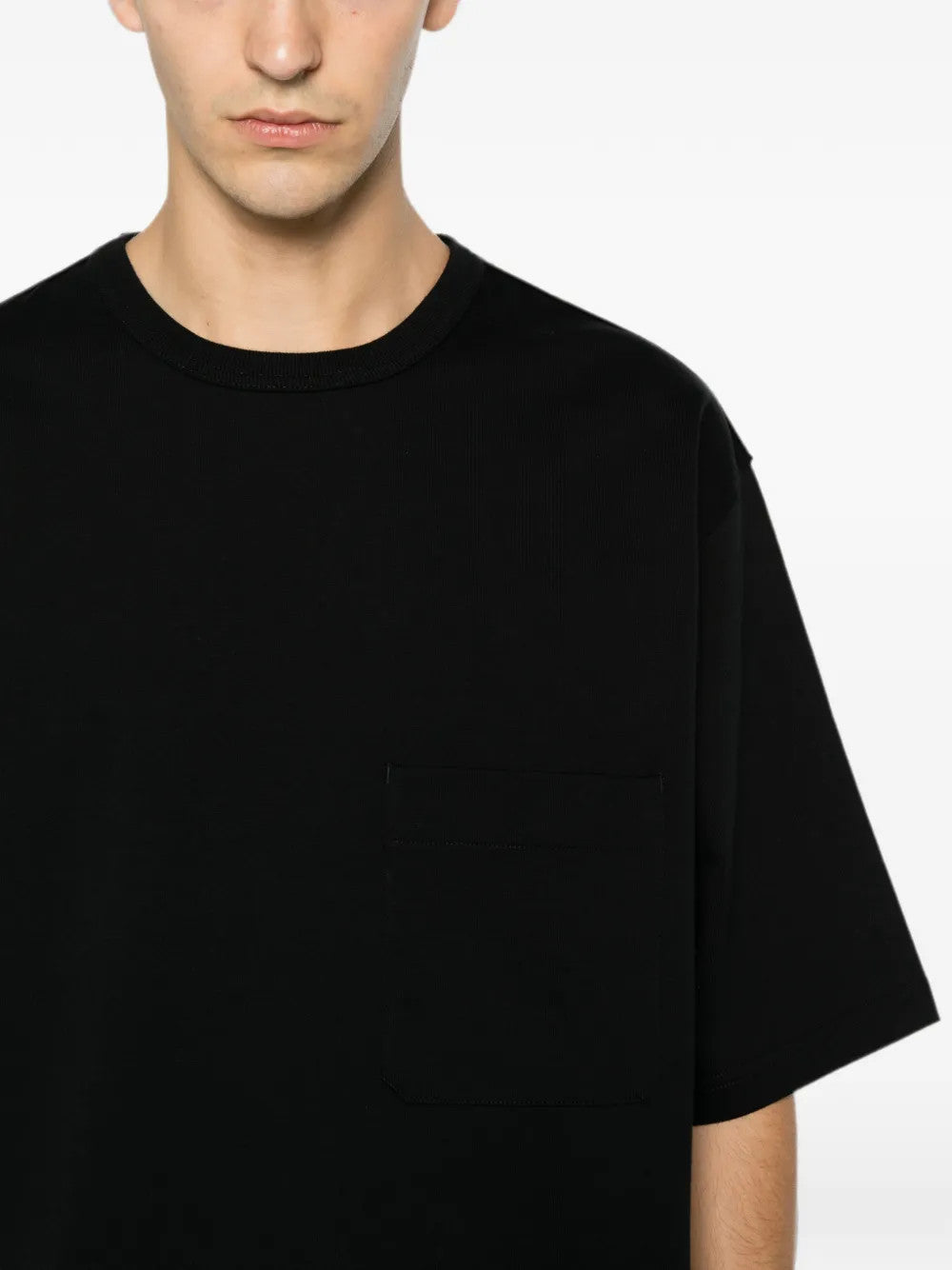 Black t-shirt worn by a person, showing the t-shirt fit