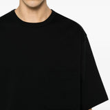 Black t-shirt worn by a person, showing the t-shirt fit