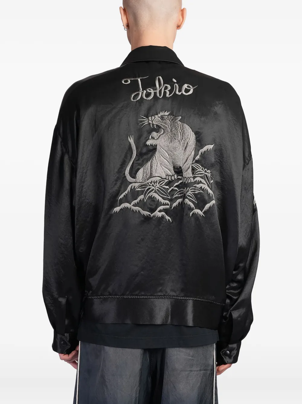 Black jacket worn by a person, showing the jacket's fit