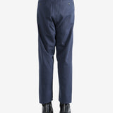 Navy pants worn by a person, showing the pants's fit