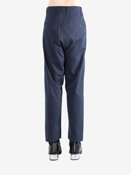 Navy pants worn by a person, showing the pants's fit