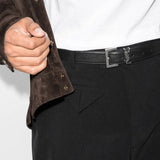 Black belt worn by a person, showing the belt's fit