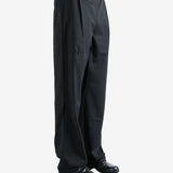 Black pants worn by a person, showing the pants' fit