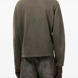 green knitwear worn by a person, showing the knitwear  fit