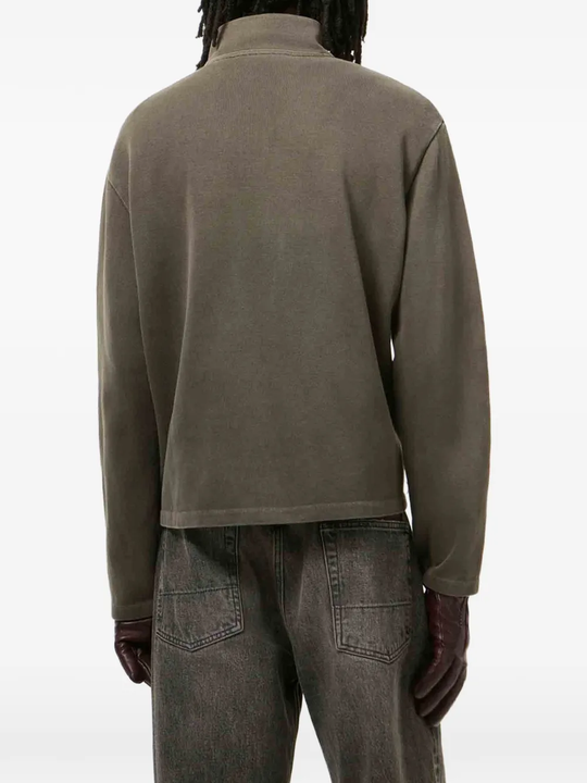 green knitwear worn by a person, showing the knitwear  fit