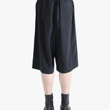 Black short worn by a person, showing the short's fit