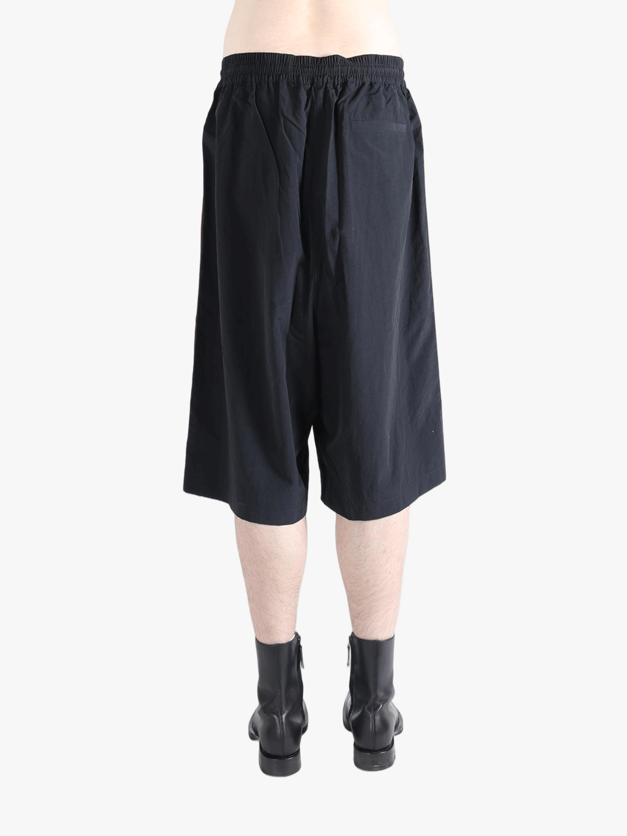 Black short worn by a person, showing the short's fit