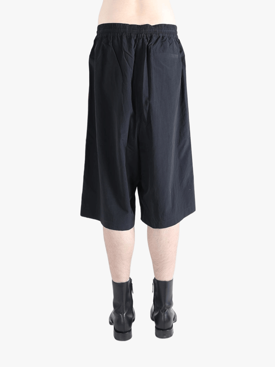 Black short worn by a person, showing the short's fit