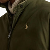 Green jacket worn by a person, showing the jacket fit