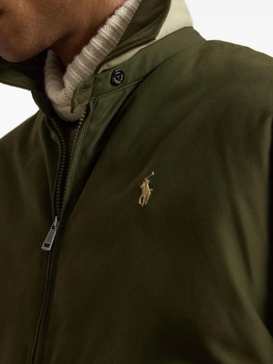 Green jacket worn by a person, showing the jacket fit