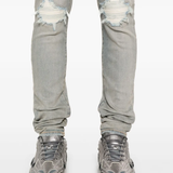 Close up of blue pants, showing texture of the cotton fabric.