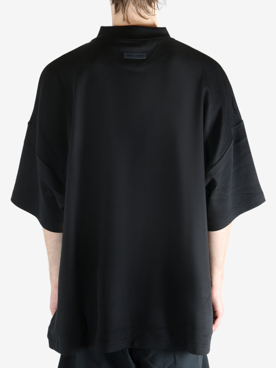 Black t-shirt worn by a person, showing the t-shirt's fit