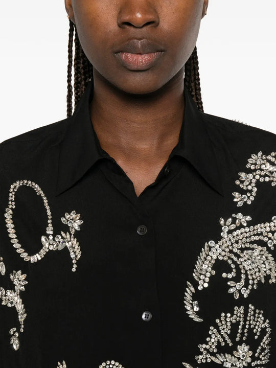 Black shirt worn by a person, showing the shirt fit