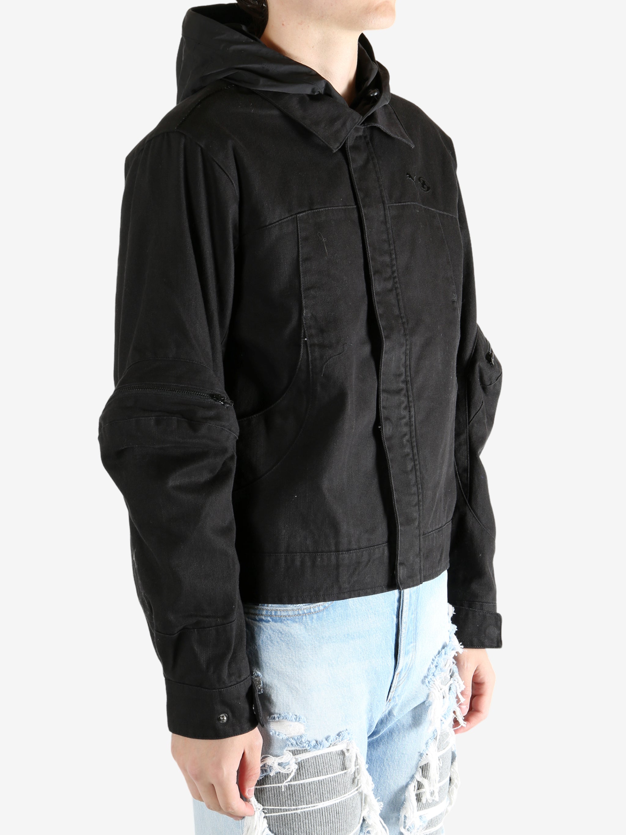 Black jacket worn by a person, showing the jacket's fit