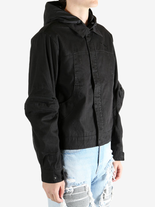 Black jacket worn by a person, showing the jacket's fit
