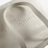 Close up of white bag, showing texture of the leather fabric