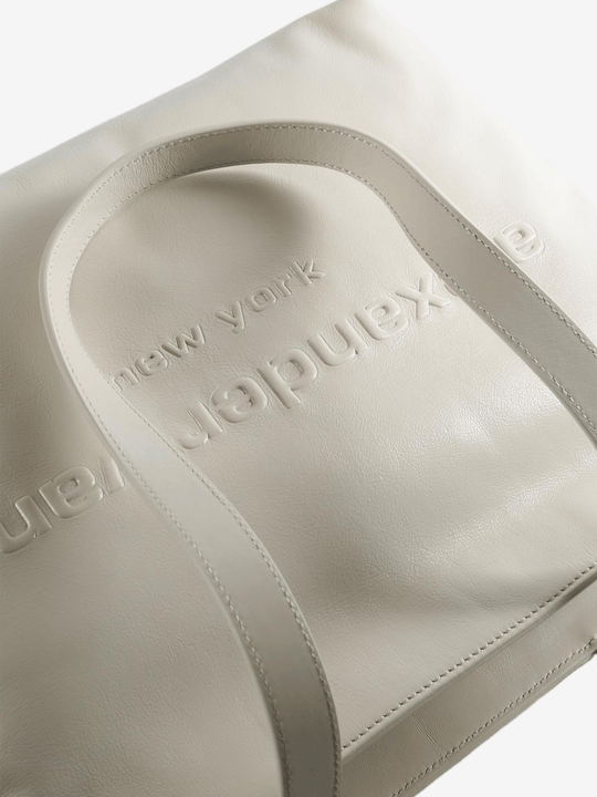 Close up of white bag, showing texture of the leather fabric
