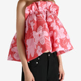 Red top worn by a person, showing the top fit