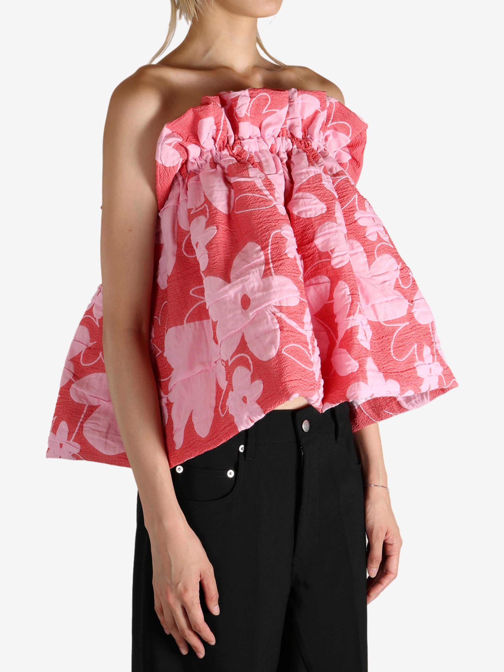 Red top worn by a person, showing the top fit