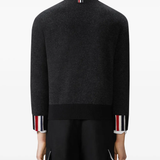 Black knitwear worn by a person, showing the knitwear fit