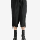 Black pants worn by a person, showing the pants's fit