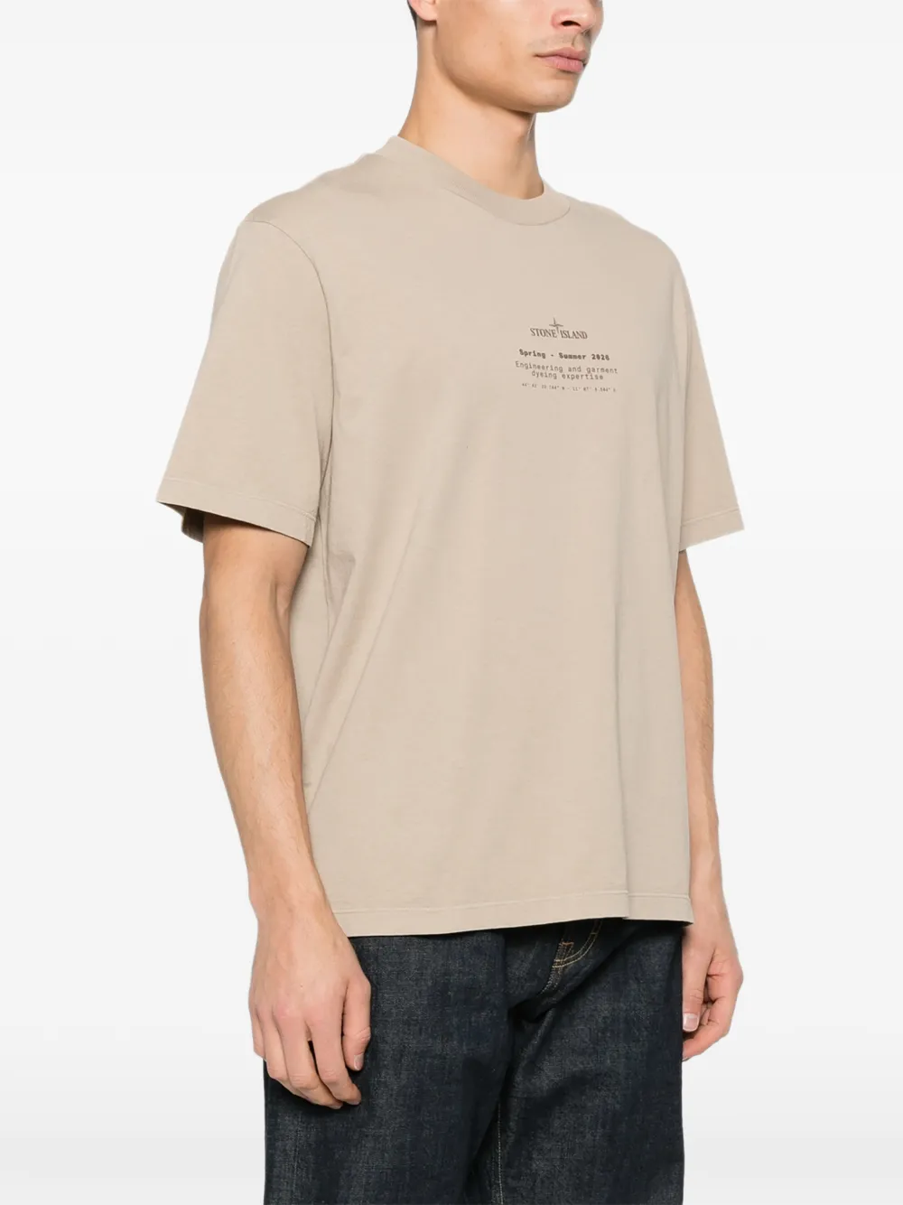 Tan t-shirt worn by a person, showing the tan t-shirt's fit