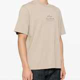 Tan t-shirt worn by a person, showing the tan t-shirt's fit