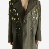 Green coat worn by a person, showing the coat fit