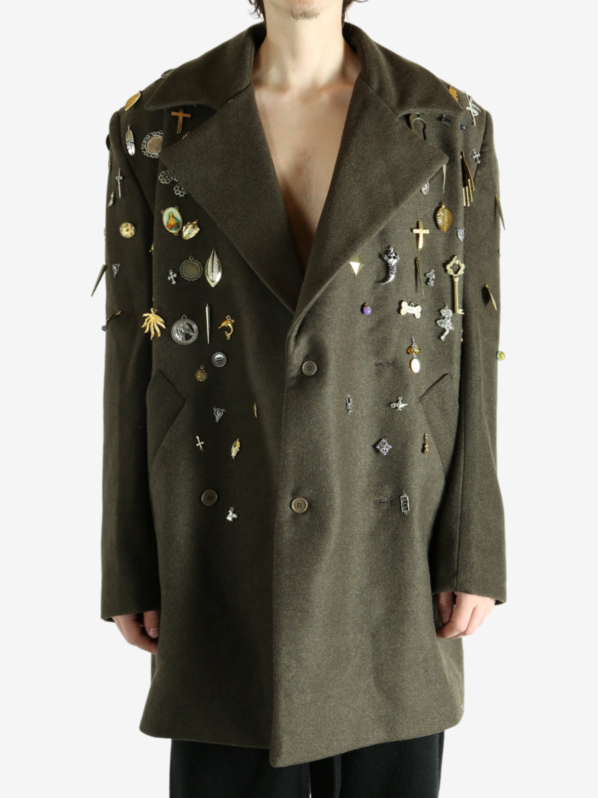 Green coat worn by a person, showing the coat fit