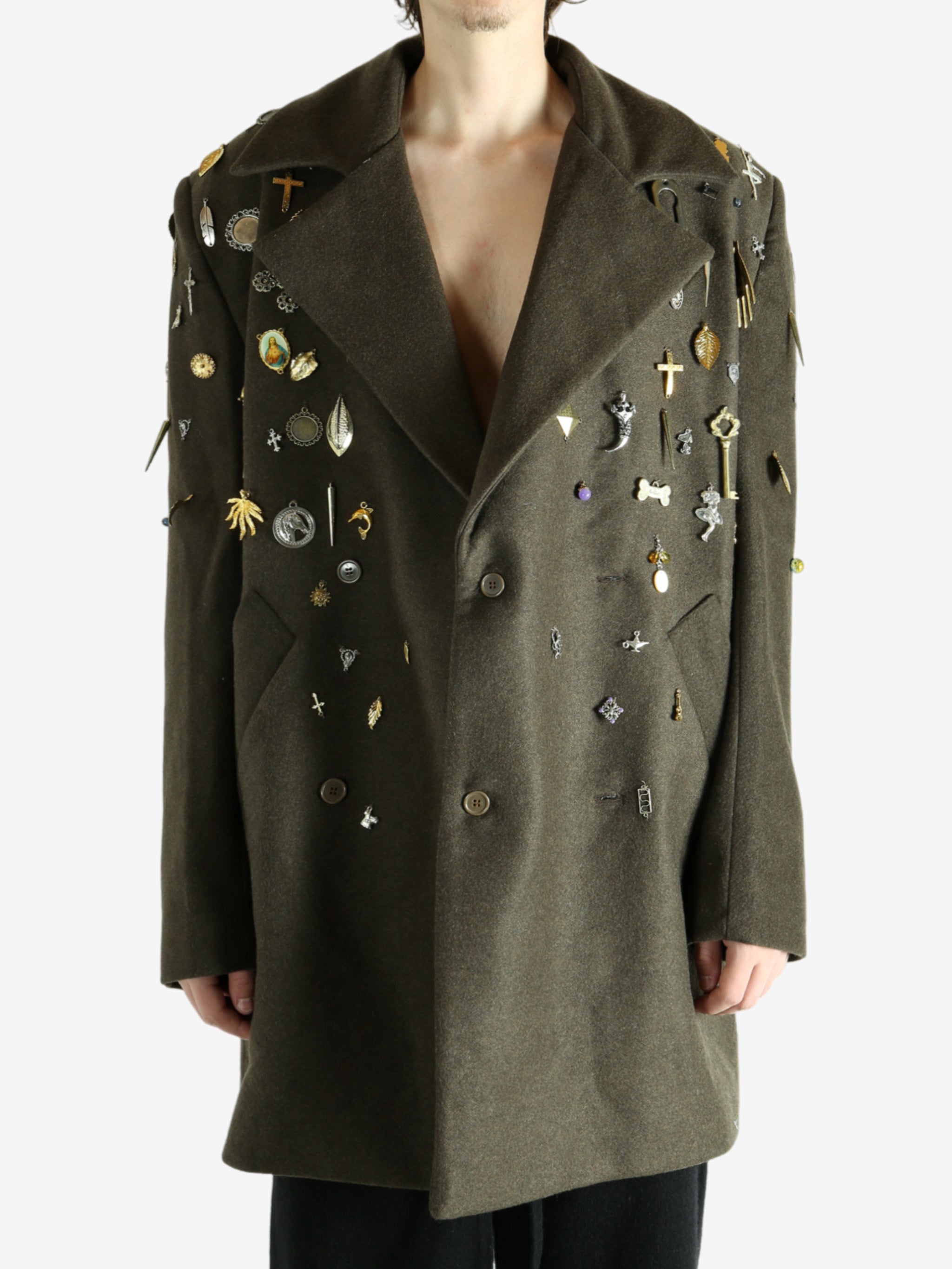 Green coat worn by a person, showing the coat fit