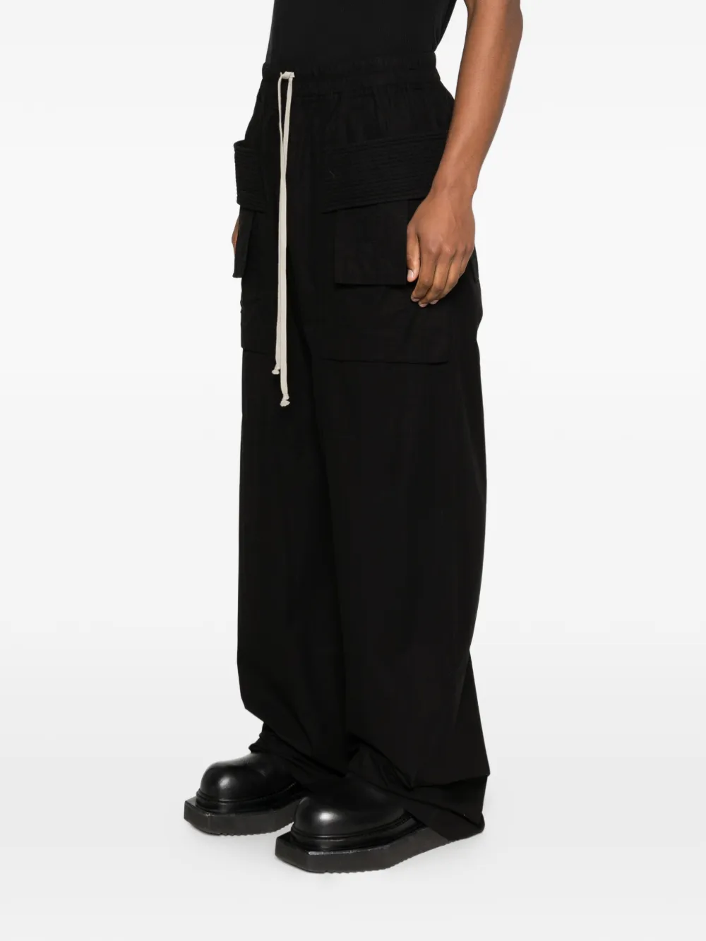 black pants worn by a person,showing the pants fit