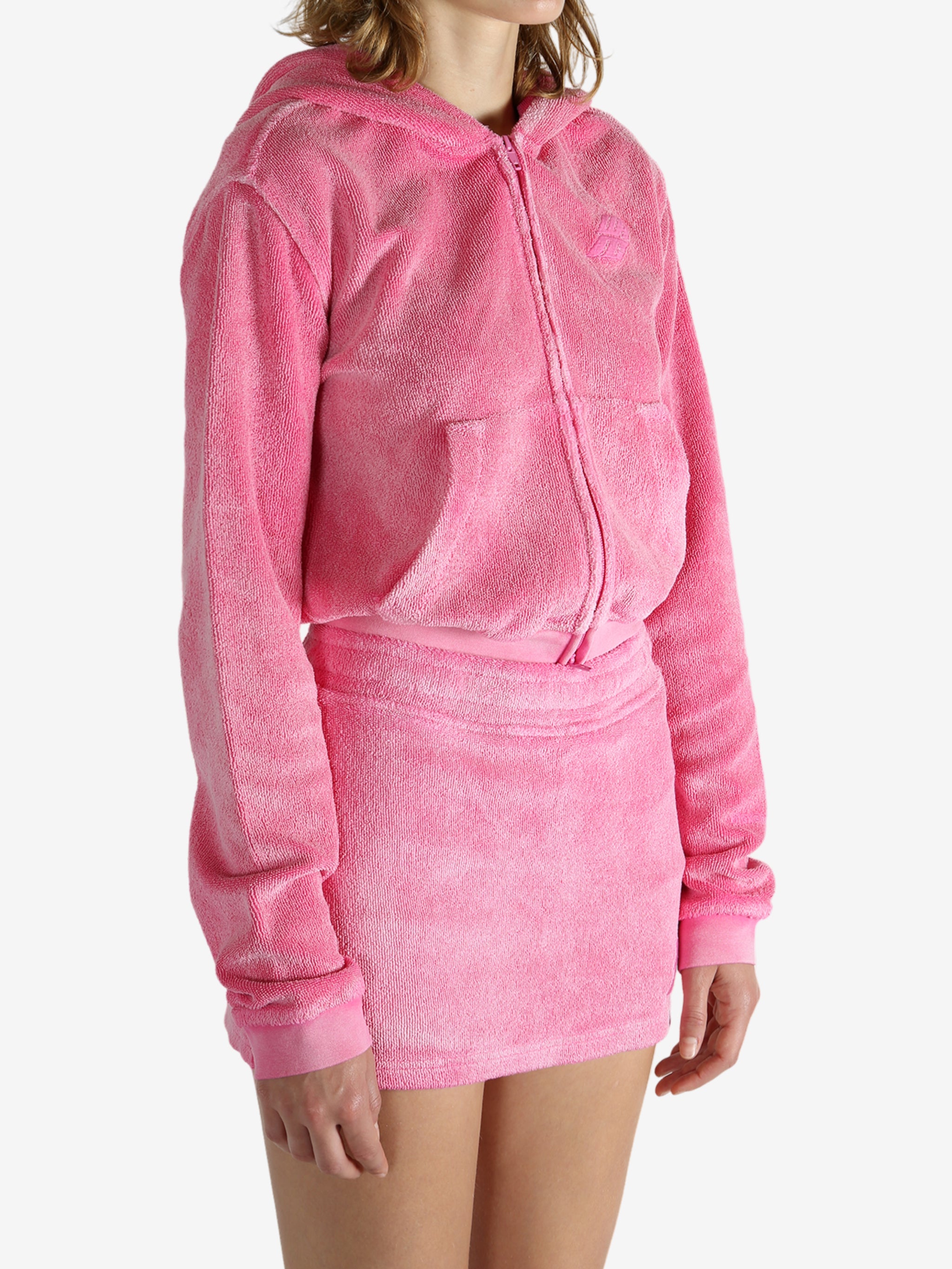 Pink hoodie worn by a person, showing the hoodie's fit