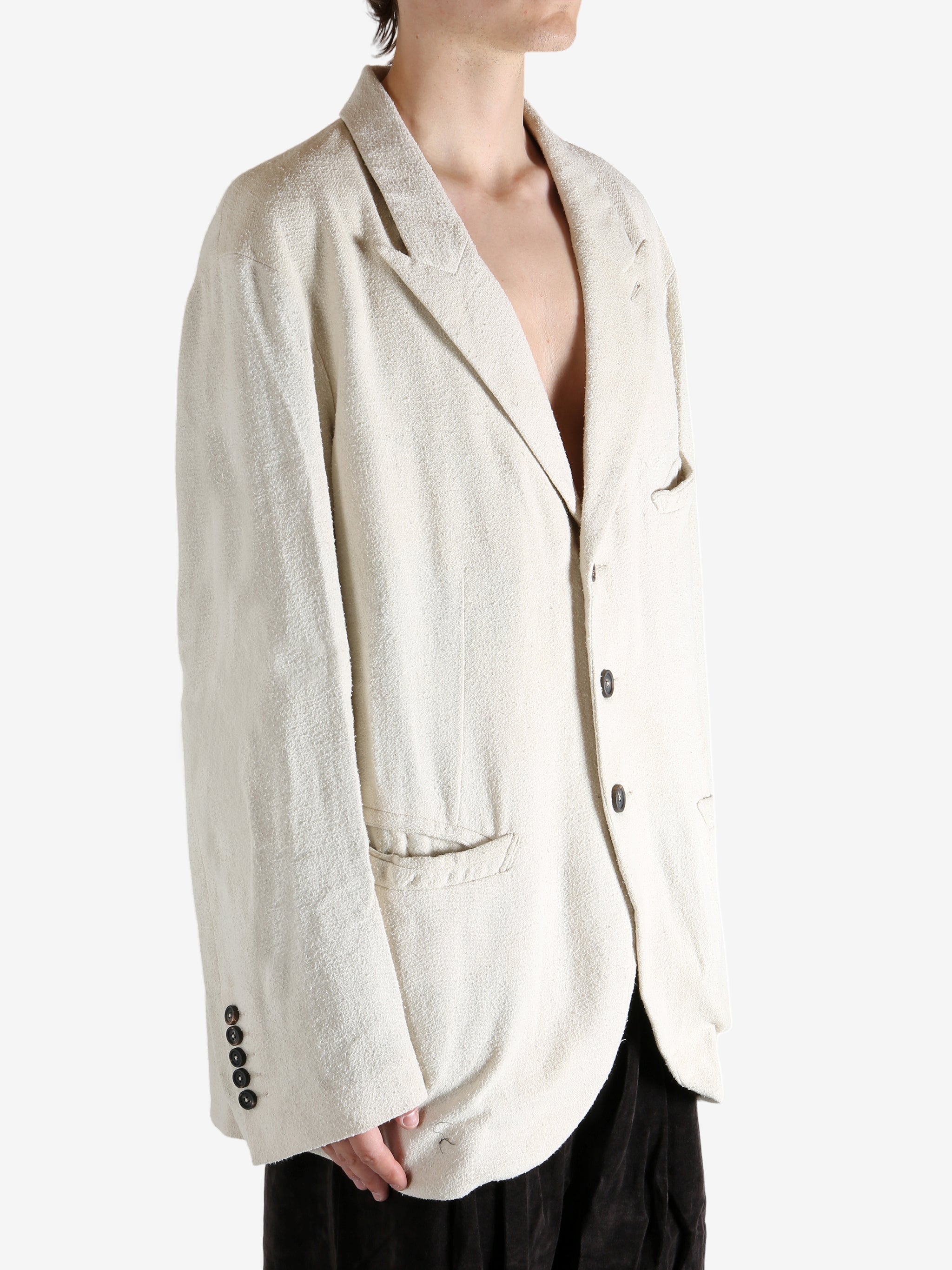 White blazer worn by a person, showing the blazer's fit