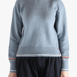 Blue pullover worn by a person, showing the pullover's fit