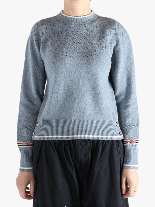 Blue pullover worn by a person, showing the pullover's fit