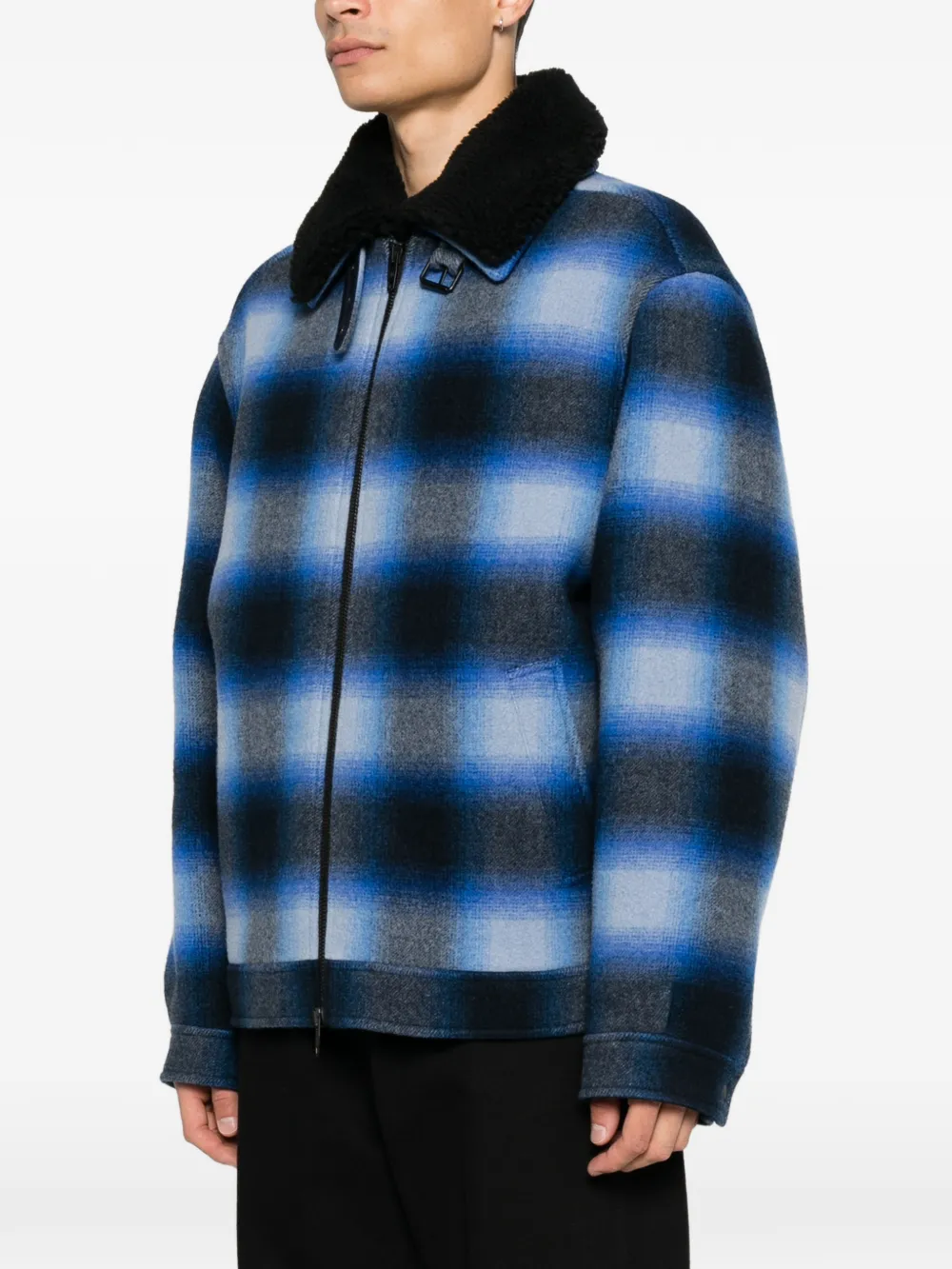 Blue jacket worn by a person, showing the jacket fit