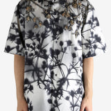 Black shirt worn by a person, showing the shirt's fit