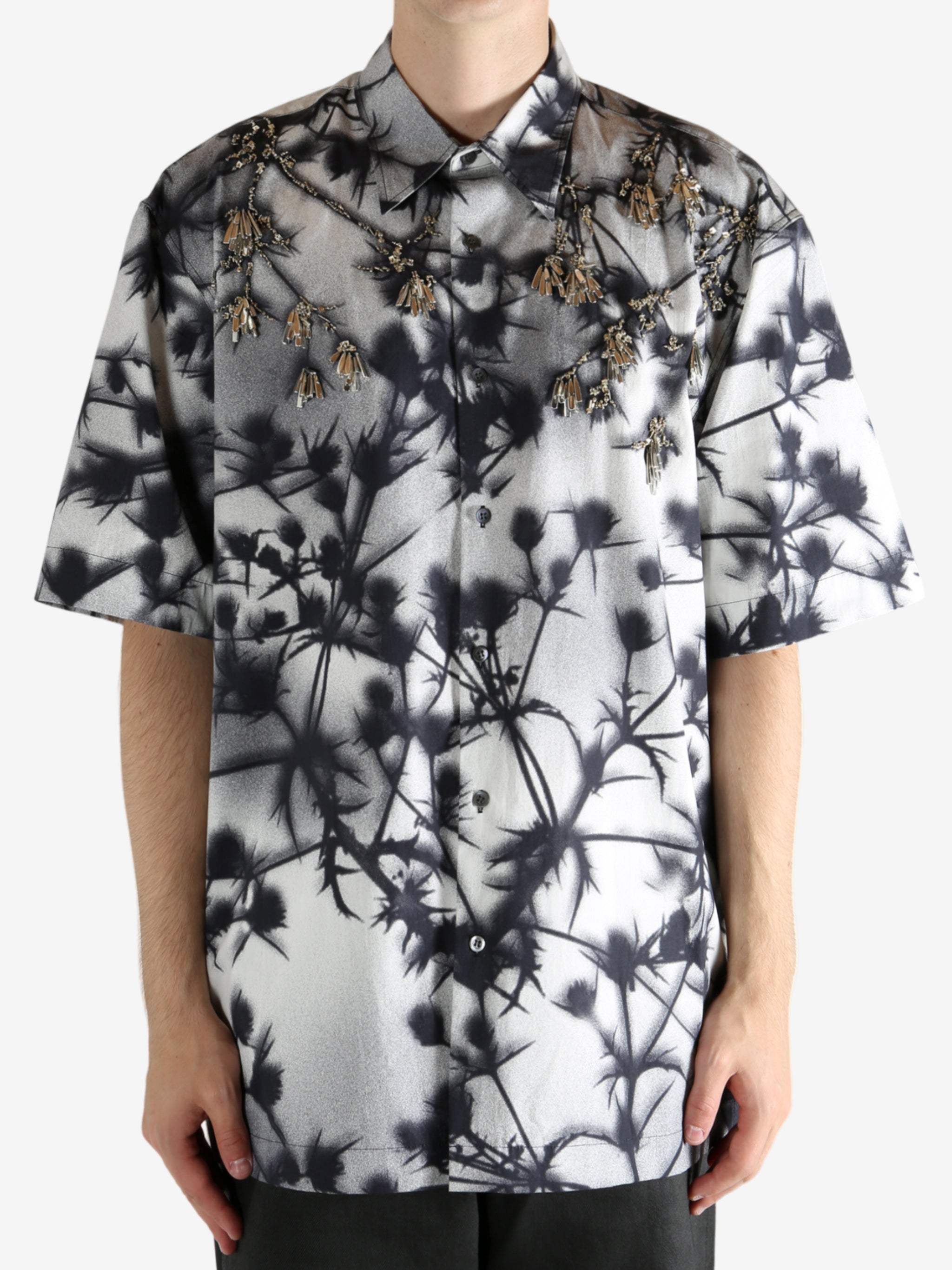 Black shirt worn by a person, showing the shirt's fit