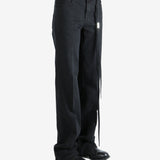 Black pants worn by a person, showing the pants' fit