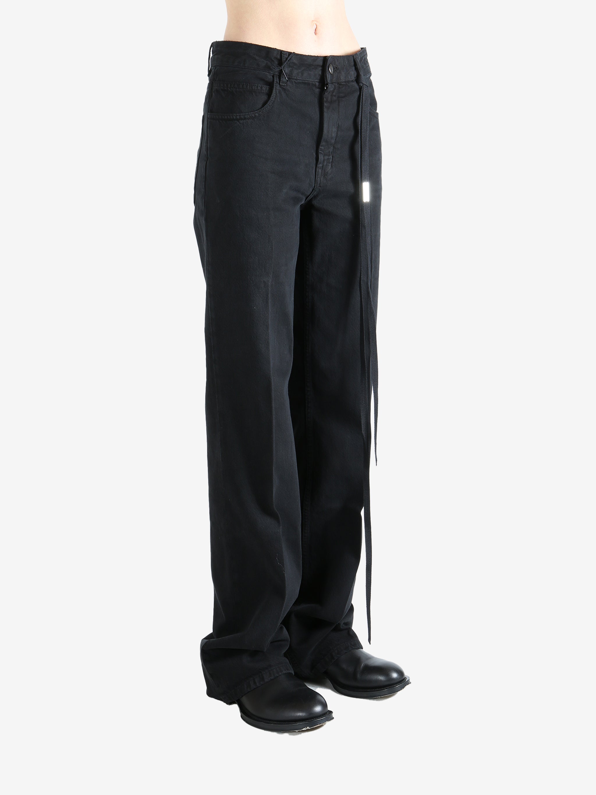 Black pants worn by a person, showing the pants' fit