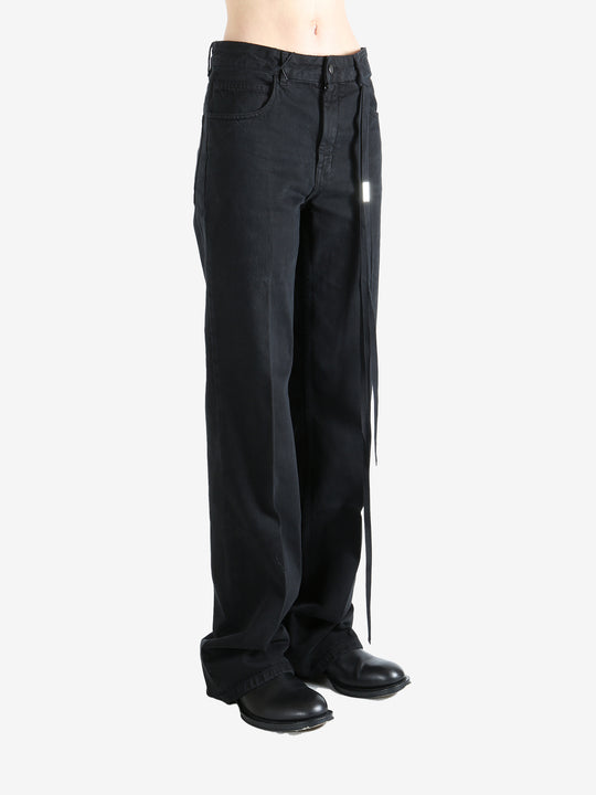 Black pants worn by a person, showing the pants' fit