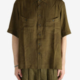 Green shirt worn by a person, showing the shirt's fit