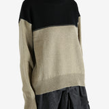 Black knitwear worn by a person, showing the knitwear fit