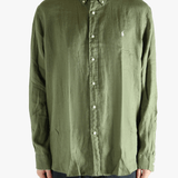 Green shirt worn by a person, showing the shirt's fit