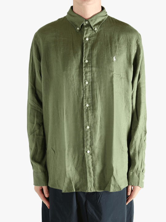 Green shirt worn by a person, showing the shirt's fit