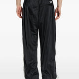 Black pants worn by a person, showing the pants fit