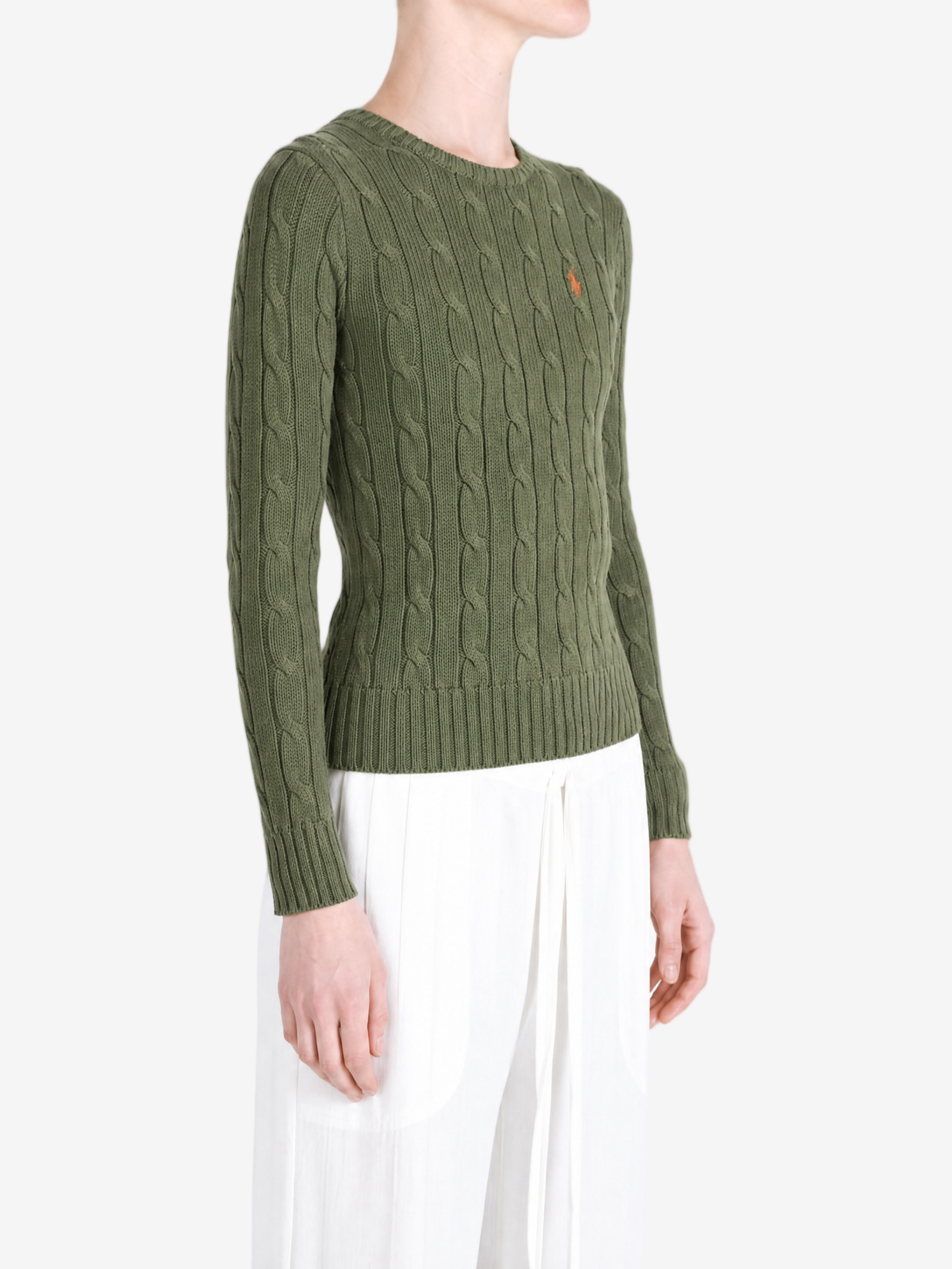 Green knitwear worn by a person, showing the knitwear fit