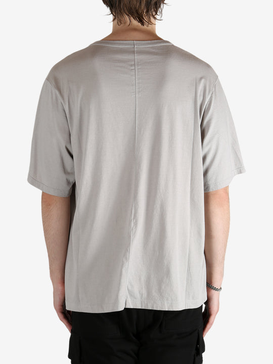 Grey shirts worn by a person, showing the shirt's fit