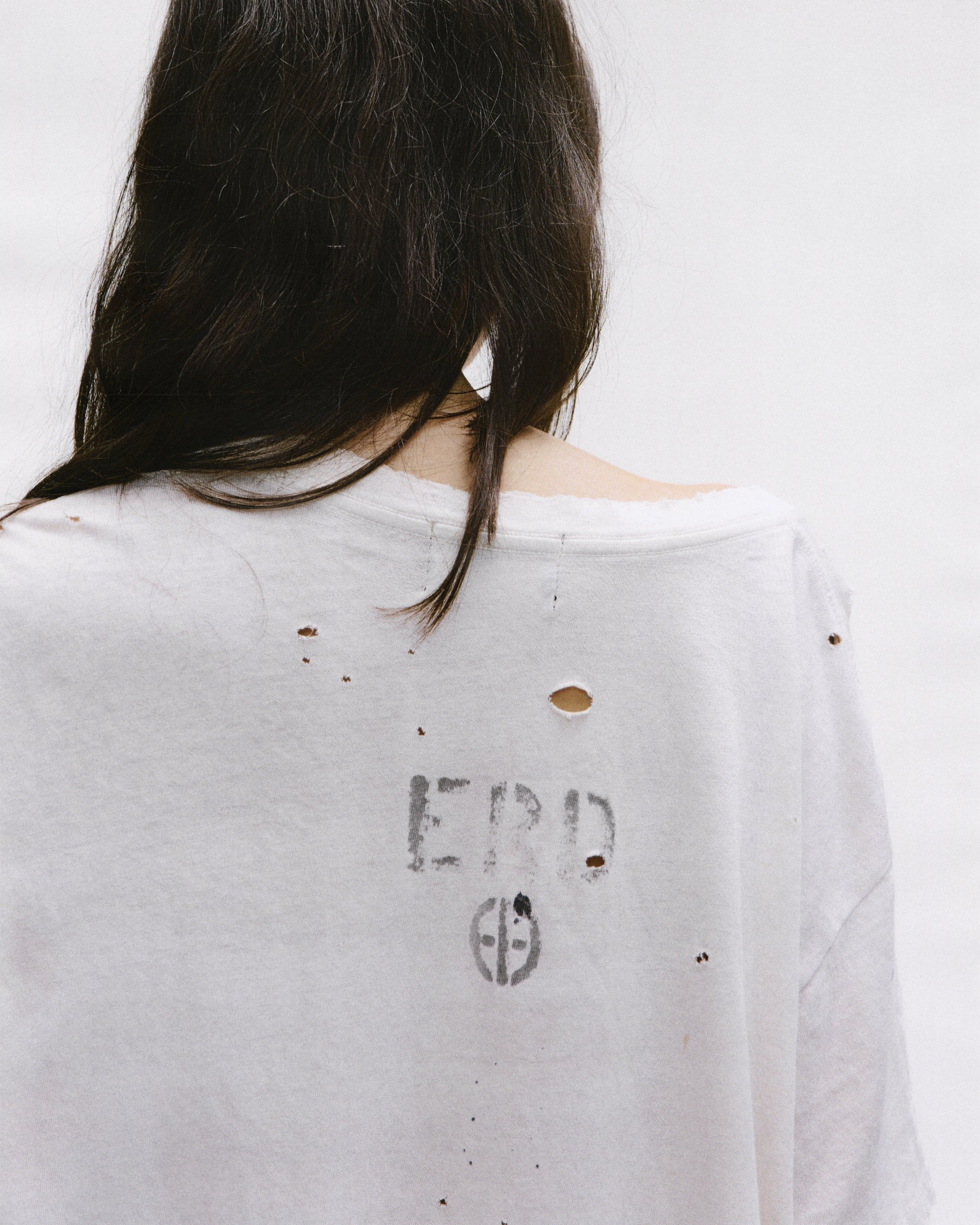 Close up of the white t-shirt, showing texture of the cotton fabric